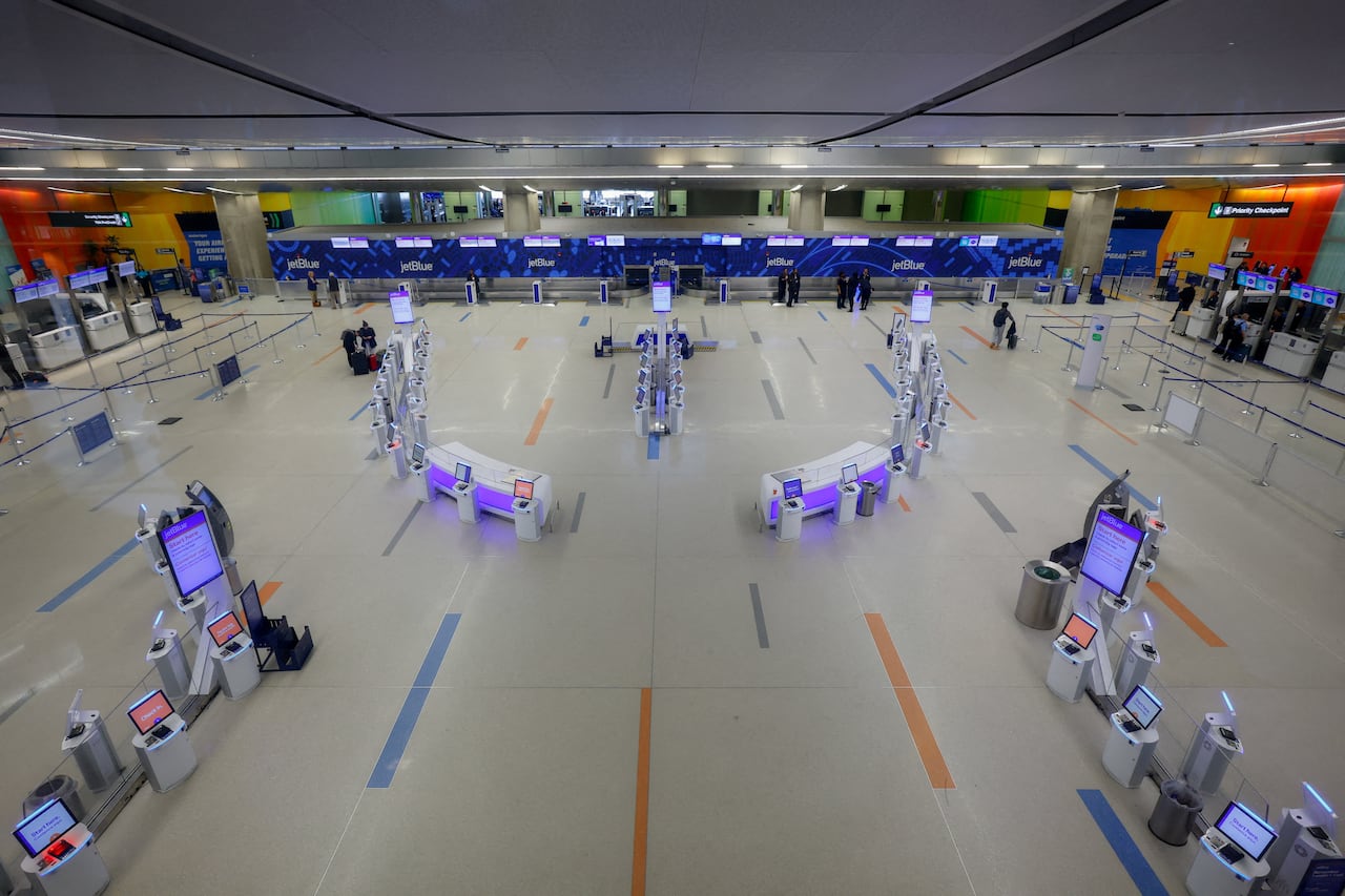 A nearly empty airport terminal is pictured.