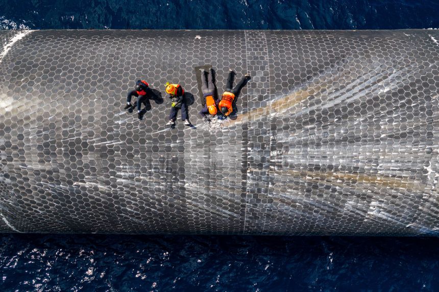 This image provided by SpaceX on August 27 shows engineers inspecting Starship off the coast of Christmas Island in the Indian Ocean, following its test flight in July. (SpaceX via AP)