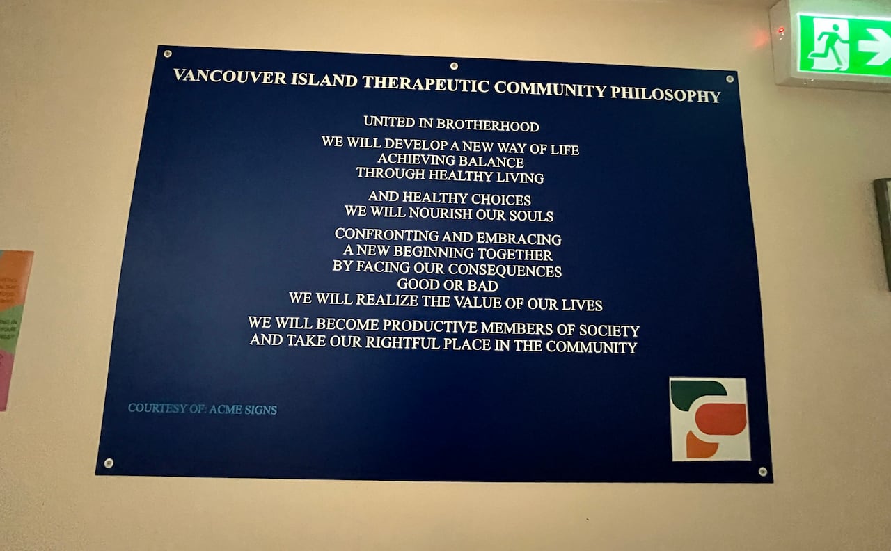 A plaque on the wall shows the text of the Vancouver Island Therapeutic Community Philosophy
