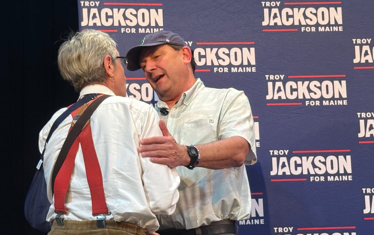 Troy Jackson speaks with a person whose back is turned to the camera.