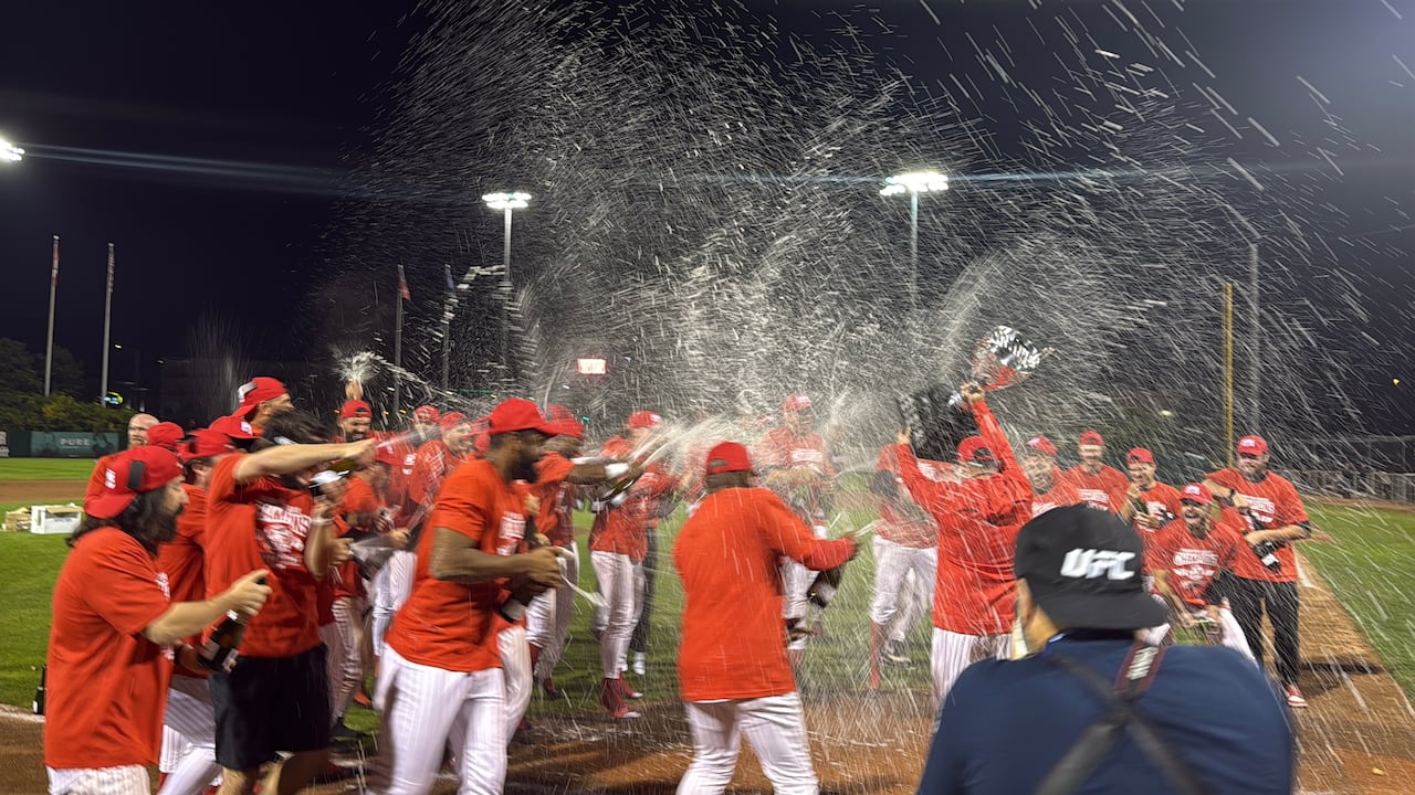A baseball team celebrating a victory with champagne.
