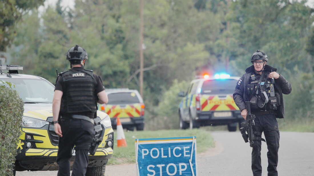 Police stand at a road block on the road to RAF Fairford after an incident, in Whelford, England, Sunday, Sept. 27, 2026,