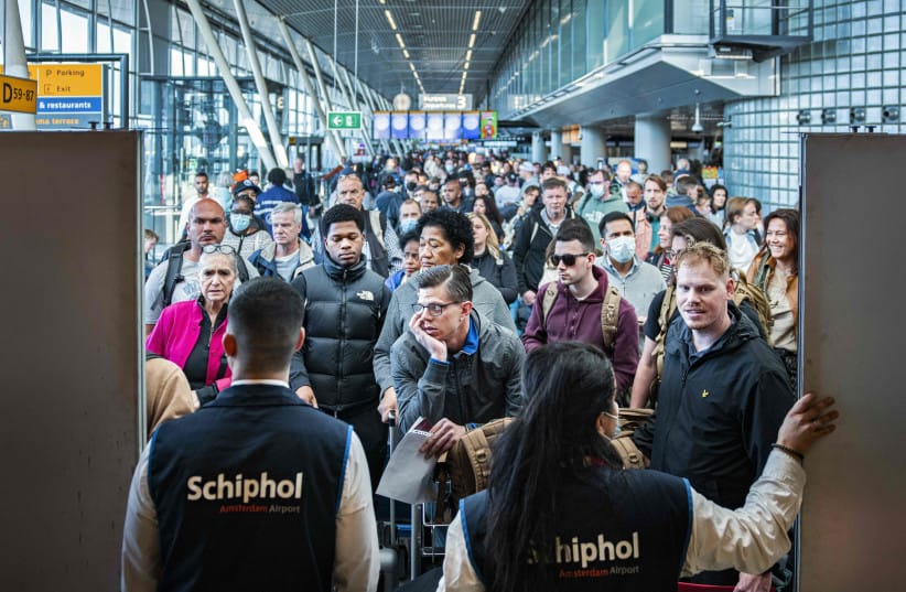 Travelers wait in a departure hall at the Netherlands's Schiphol airport, a day after a strike by KLM luggage handlers caused many flights to be canceled, near Amsterdam, April 24, 2022