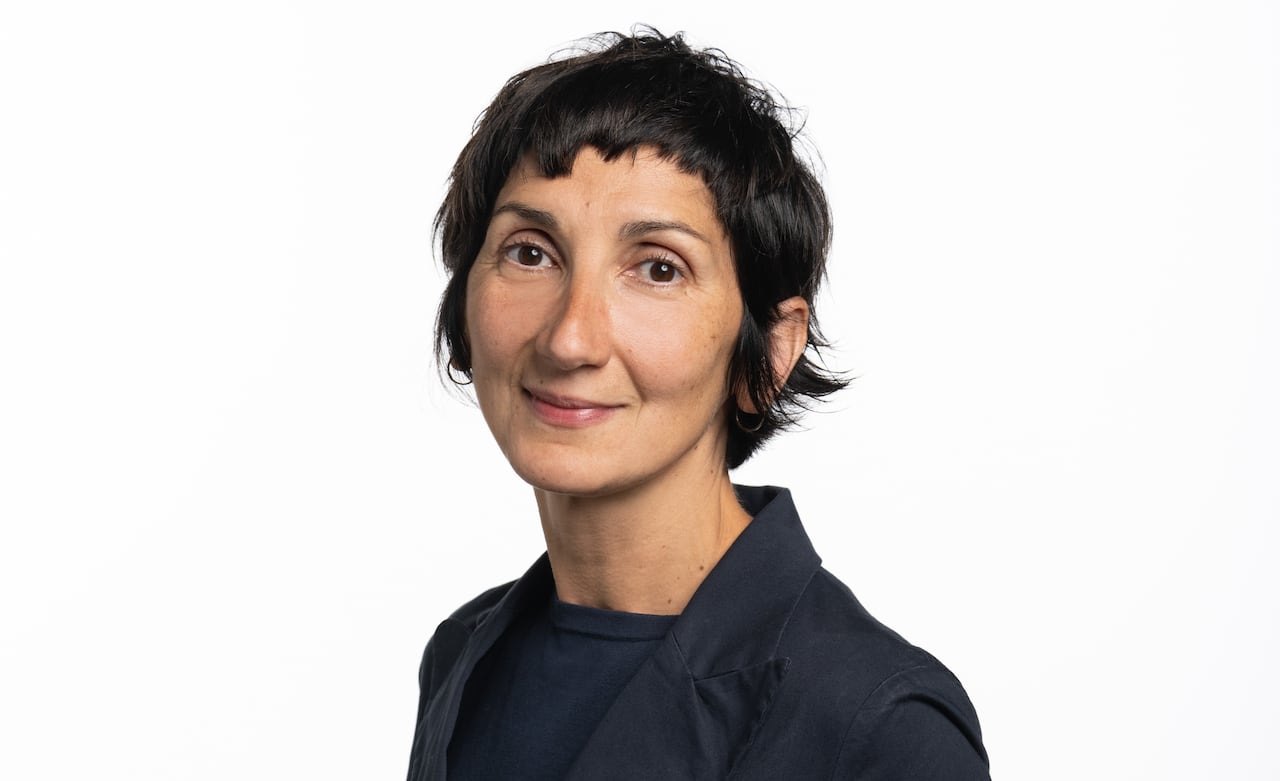 a professional shot of a woman with short hair and a suit
