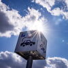 A sign offers parking and charging facilities for electric cars at a retail park in Berlin in 2023. Evidence from the oldest generation of electric vehicles suggests their batteries are lasting longer than was expected in the early days of the EV industry.