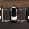 Electric cars sit parked at a charging station in Corte Madera, Calif., in May 2025.