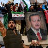 People hold a banner featuring Turkish President Recep Tayyip Erdogan as members of the Syrian community and supporters gather in Istanbul to celebrate the fall of Syrian President Bashar al-Assad in the face of an offensive by Islamist-led rebels, on Dec. 8.