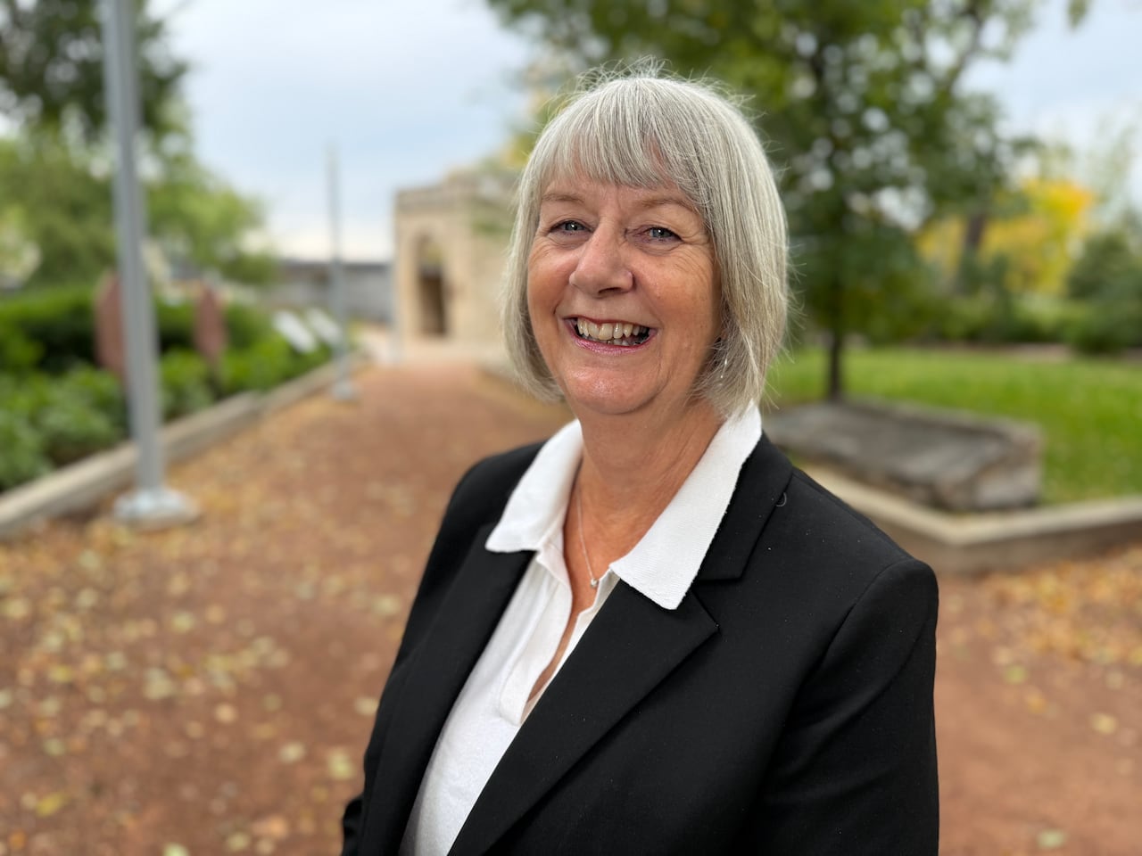 woman standing in a park and smiling