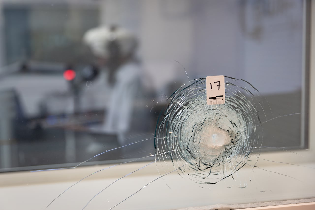 Bullet holes remain in the glass at Radio Swift 1200 AM. The station was the subject of an extortion attack allegedly tied to Ravinder Singh, a suspect who faces deportation for organized criminality.