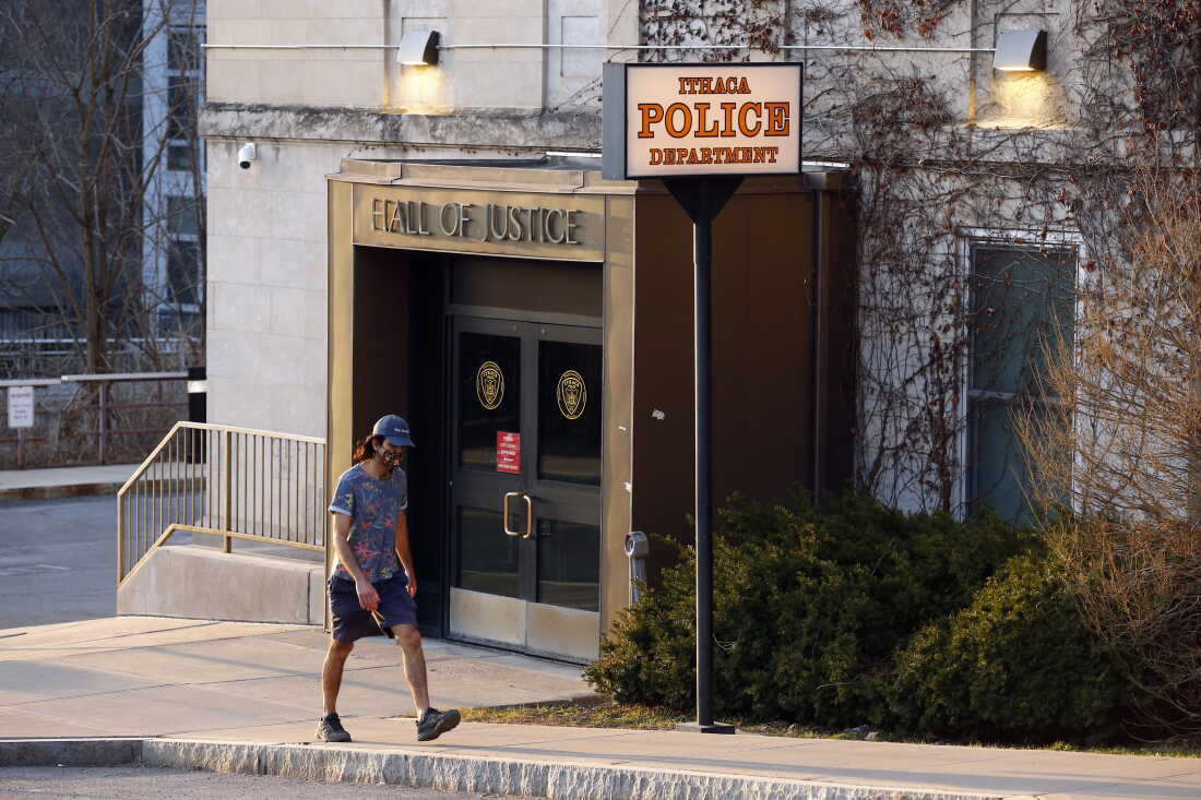 A person walks by the Ithaca Police Department headquarters on March 22, 2021, in Ithaca, N.Y.