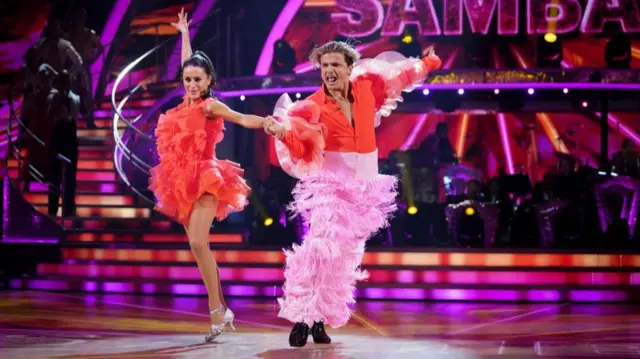 Nikita Kuzmin (R) and Amber Davies perform during instant dance challenge