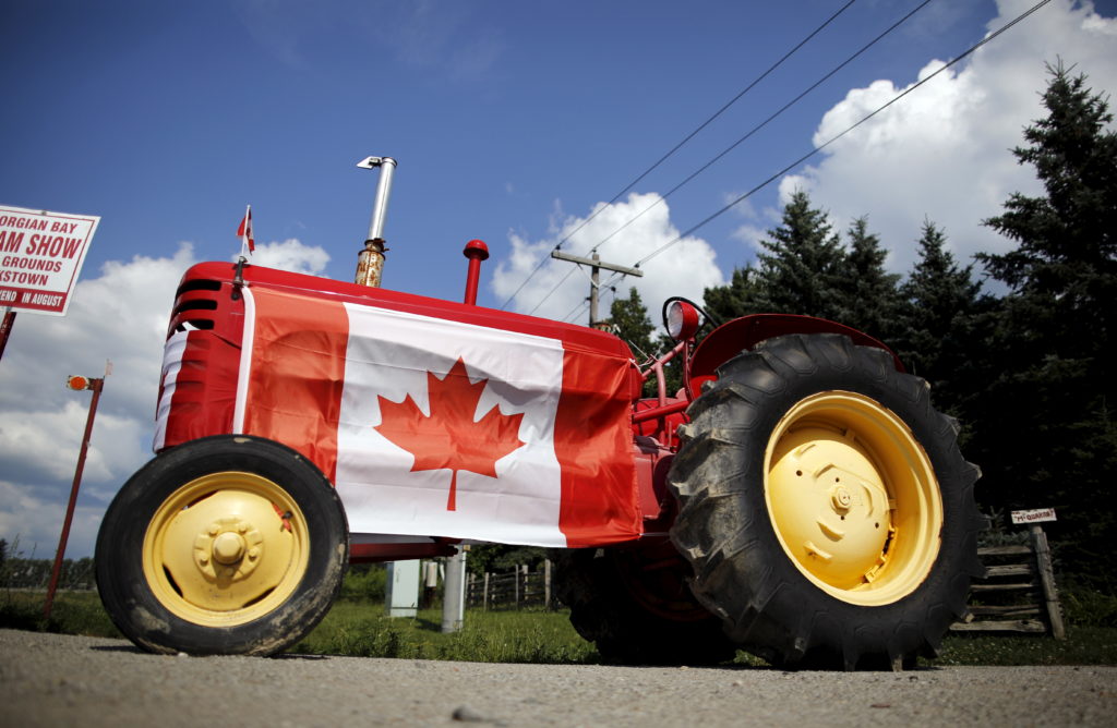 Old tractor sporting a Canadian national flag is seen parked in the rural township of Oro-Medonte, Ontario