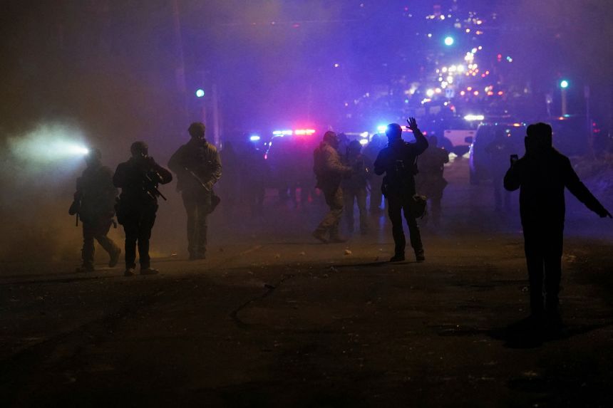 Federal agents fire munitions and pepper balls as community members protest, as tensions rise after federal law enforcement agents were involved in a shooting incident in north Minneapolis, on January 14.