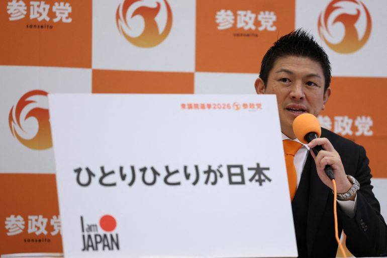 Japan’s far-right Sanseito party leader, Sohei Kamiya, shows his party’s election pledge during a news conference after Japan’s Prime Minister Sanae Takaichi dissolved the lower house of parliament, in Tokyo, January 23, 2026