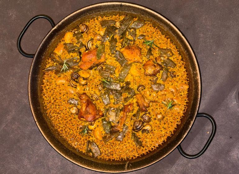 A Paella valenciana, made with rabbit, chicken, snails, and vegetables is served at La Matandeta restaurant in Valencia, Spain, January 4, 2026. REUTERS/Maria Martinez
