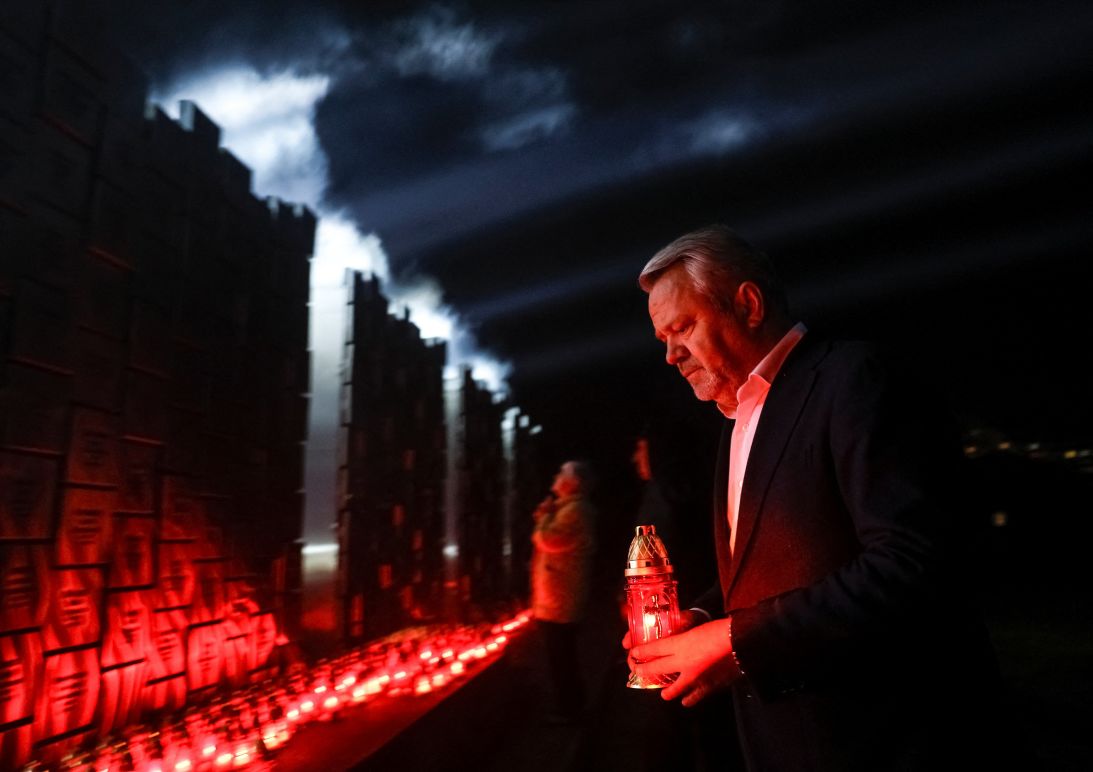 Anatolii Fedoruk, mayor of Bucha, brings a candle to pay tribute at the memorial installation for the victims of attacks and executions by Russian troops on the fourth anniversary of the liberation of the town of Bucha outside Kyiv, Ukraine on March 30.