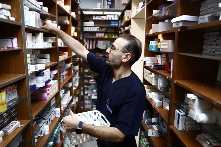 A pharmaceutical worker works in a pharmacy in Tehran, Iran, in April.