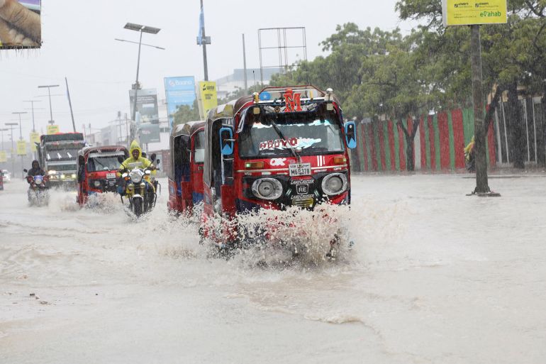 Rickshaw tuktuks drive through floodwater along KM4 street, following a heavy downpour in Mogadishu, Somalia, June 21, 2026. REUTERS/Feisal Omar