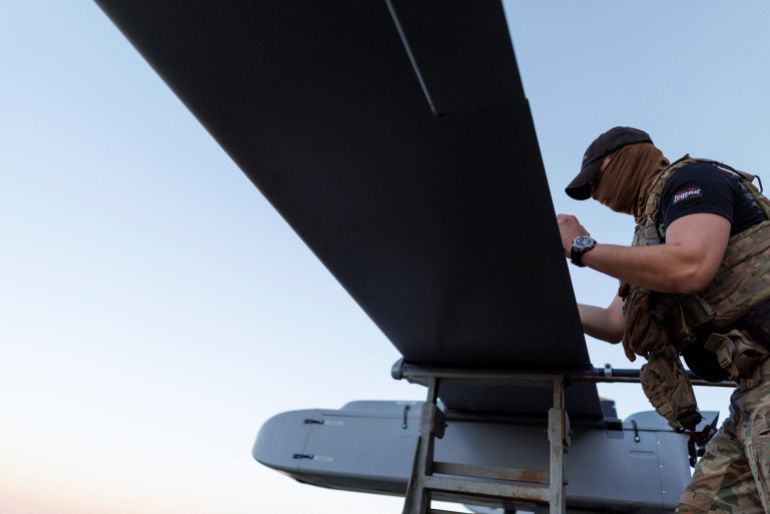 A service member of the 414th Separate Unmanned Strike Aviation System Brigade ‘Magyar’s Birds’ of the Ukrainian Armed Forces writes a message to Russians on an FP-1 deep-strike drone before it launches for a combat mission in an undisclosed location in Ukraine