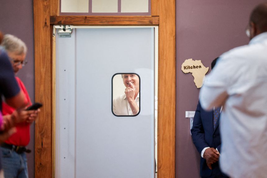 California Governor Gavin Newsom peers through a window before meeting with voters and local leaders while campaigning for Democrats ahead of the midterm elections in Aiken, South Carolina, September 4, 2026.
