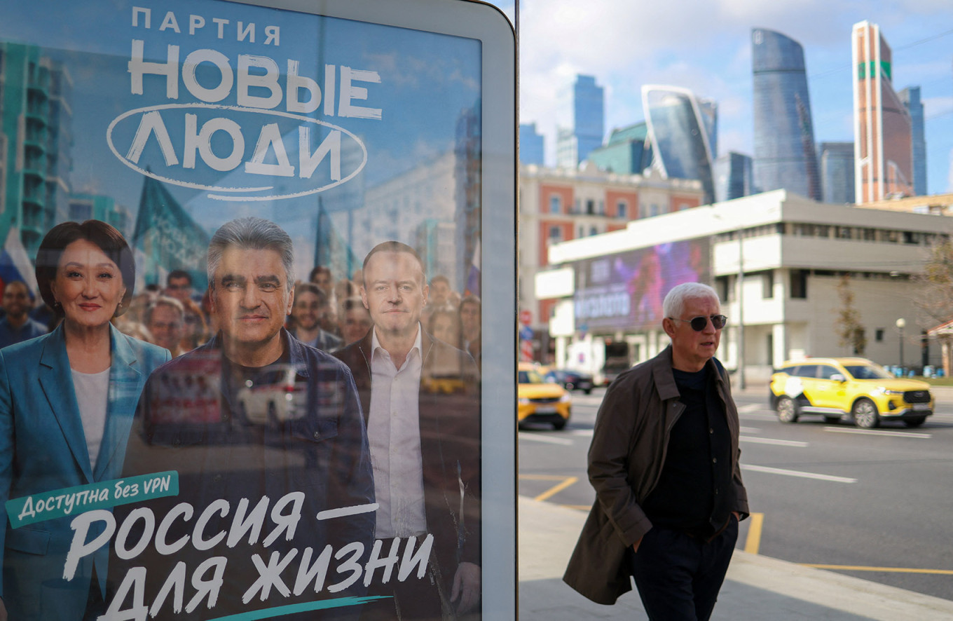 
					A man walks past a billboard promoting the New People party in Moscow.					 					REUTERS / Ramil Sitdikov				