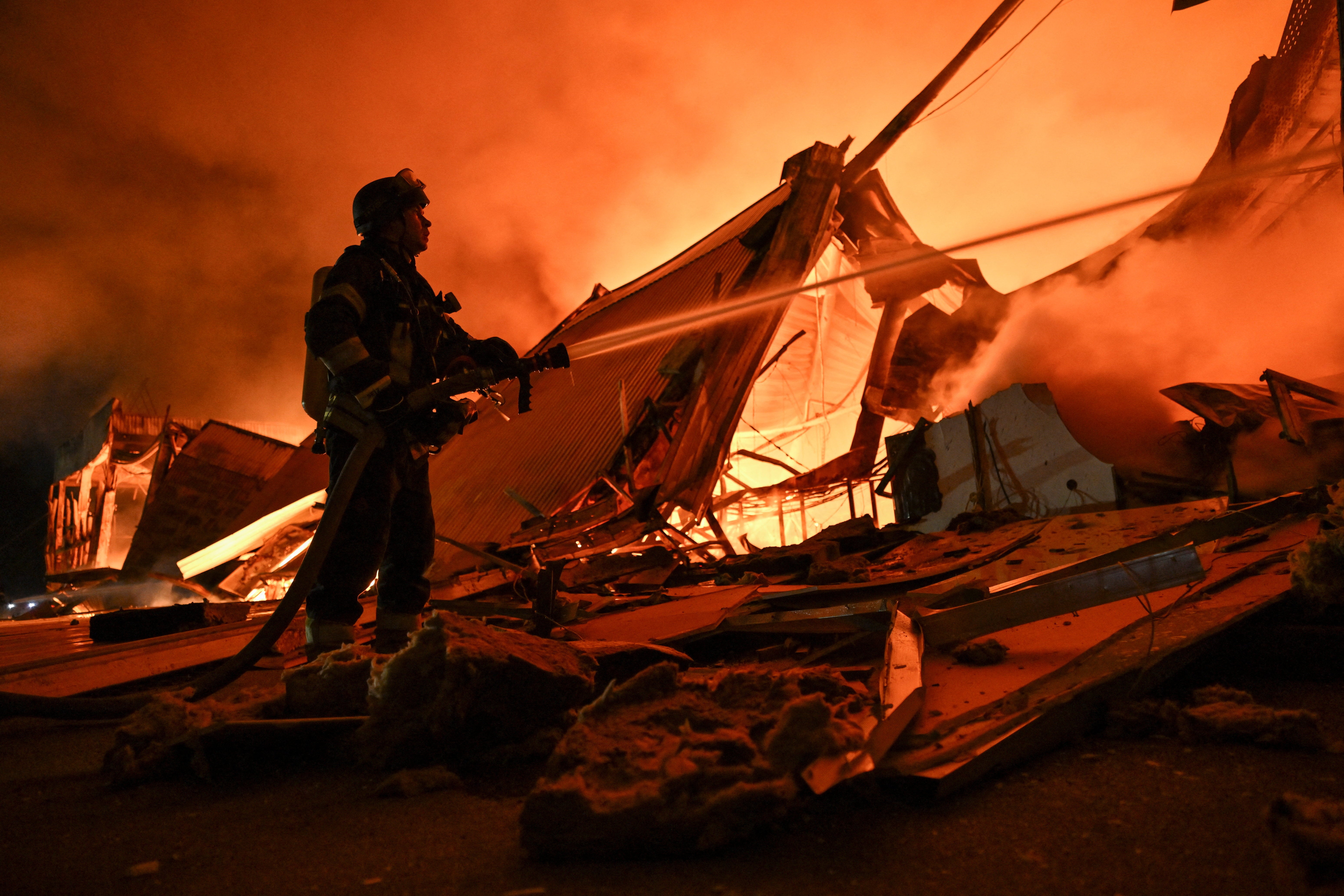 A firefighter works at the site of a shopping mall which was hit by a late evening Russian drone strike in Zaporizhzhia, Ukraine September 17, 2026