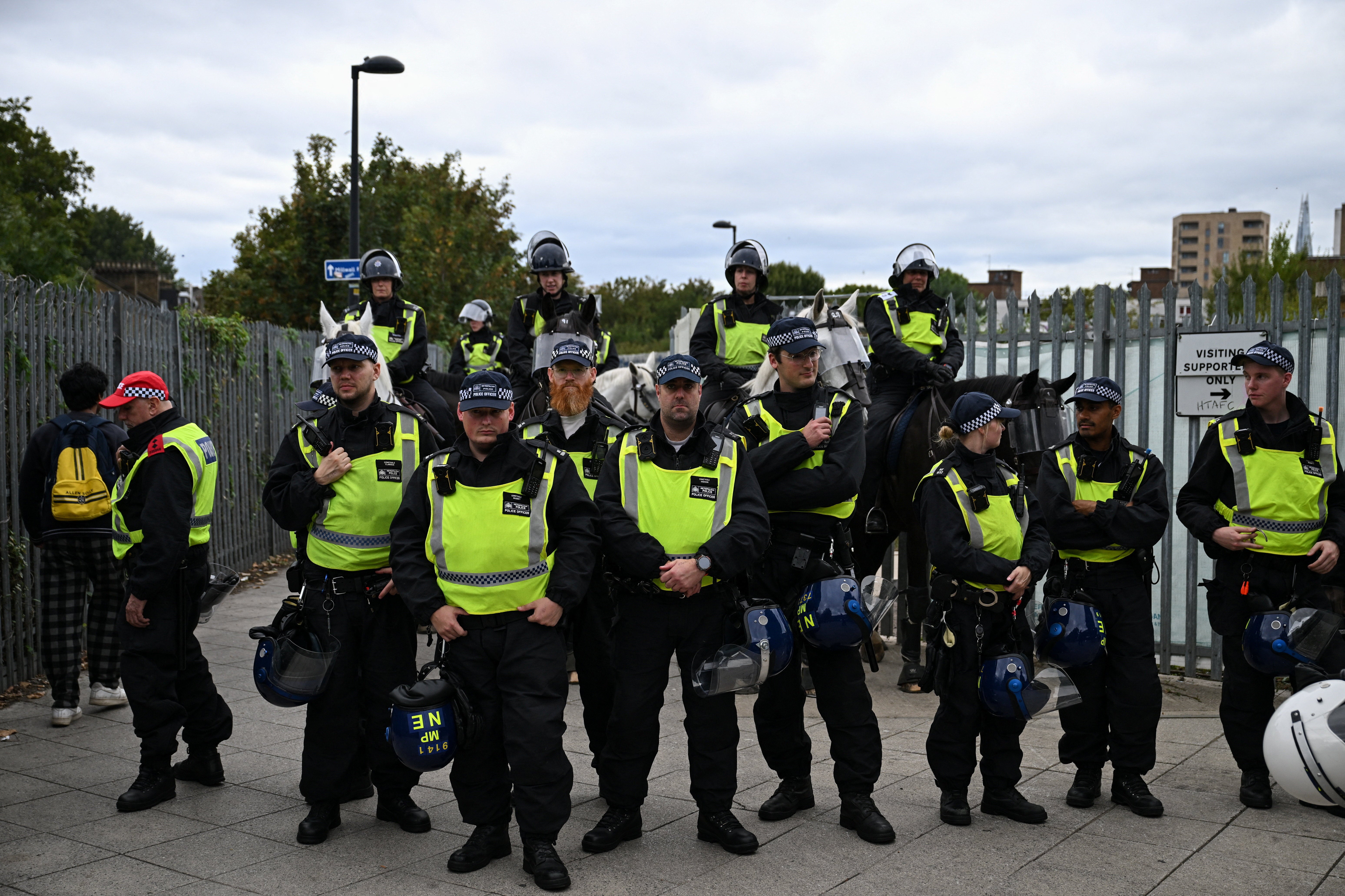 Mounted police and officers with riot helmets outside South Bermondsey train station as fans travel through the station following the Millwall v West Ham United English Football League Championship game at The Den, in London, Britain, September 19, 2026. REUTERS/Chris J. Ratcliffe