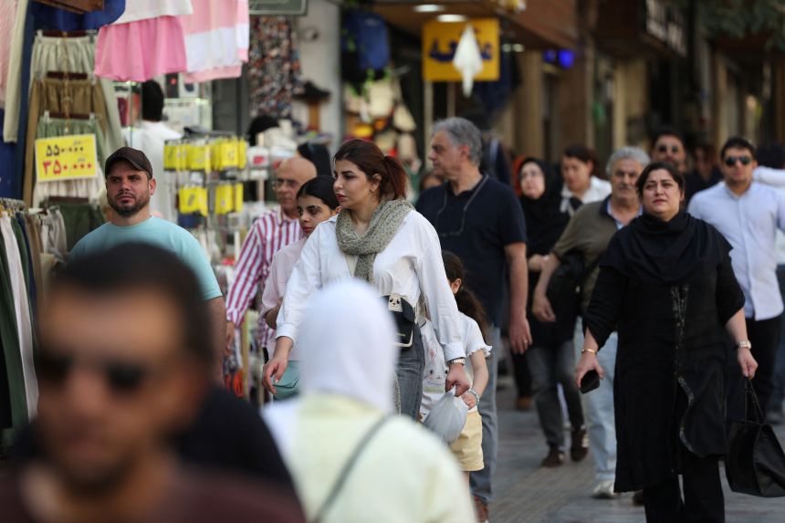People walk on a street in Tehran, Iran, September 23, 2026.