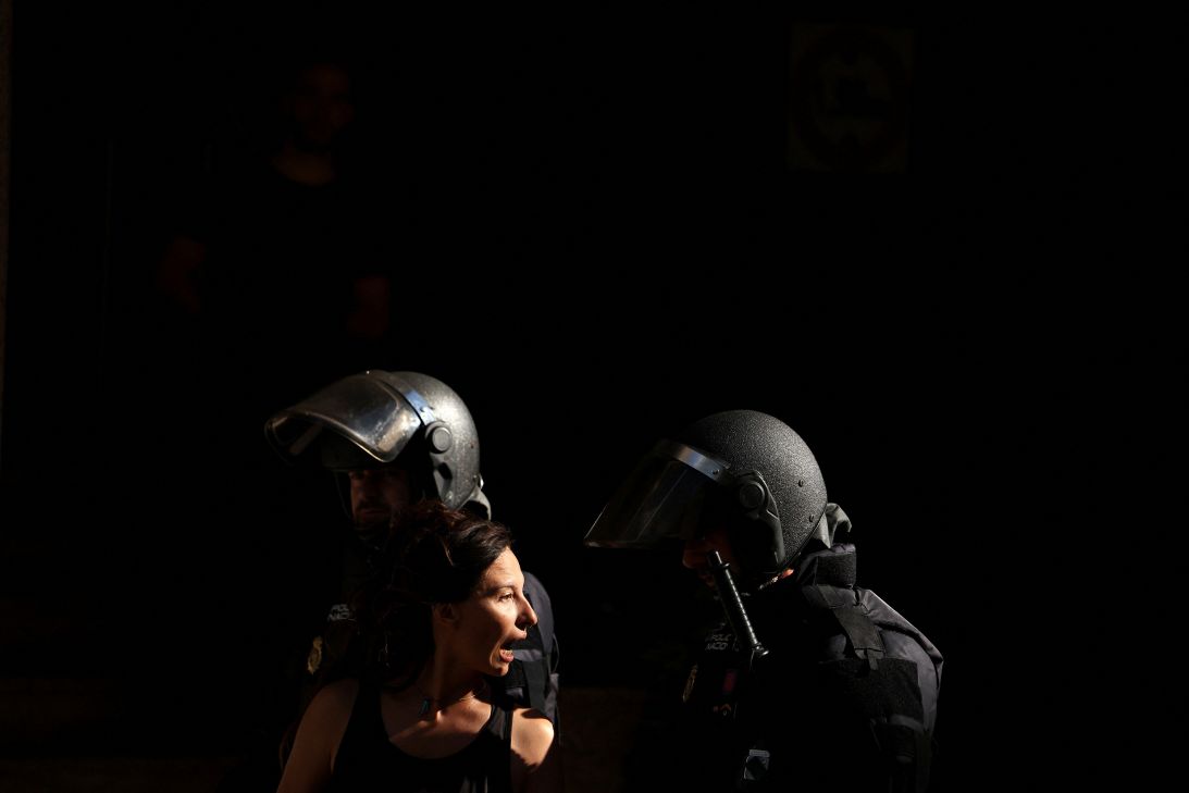 Spanish riot police remove a housing activist, who was trying to prevent the eviction of Maricarmen Abascal, 87, in Madrid, Spain, on September 23.