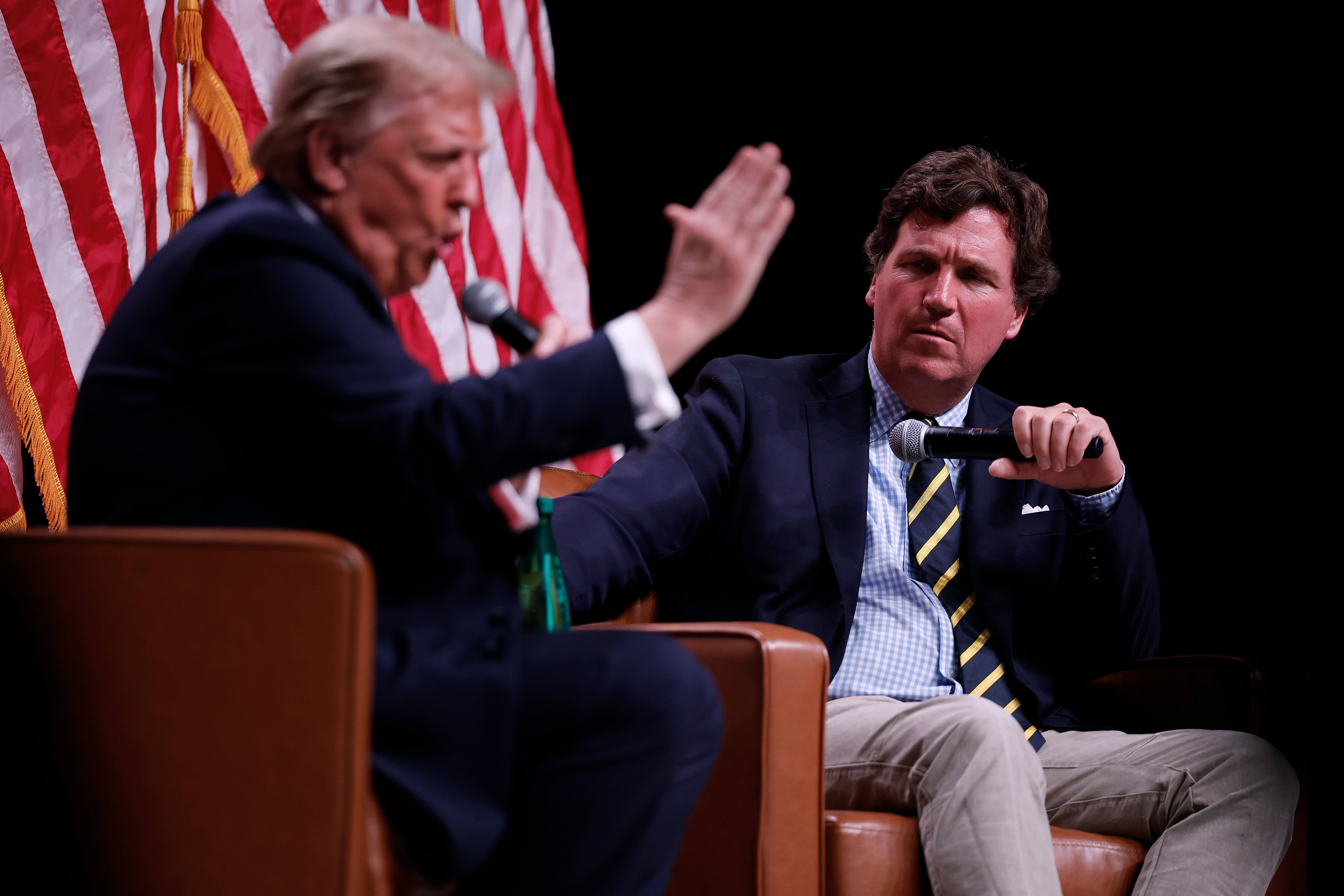 Trump sits for an interview with Carlson, during the podcaster’s live tour in 2024