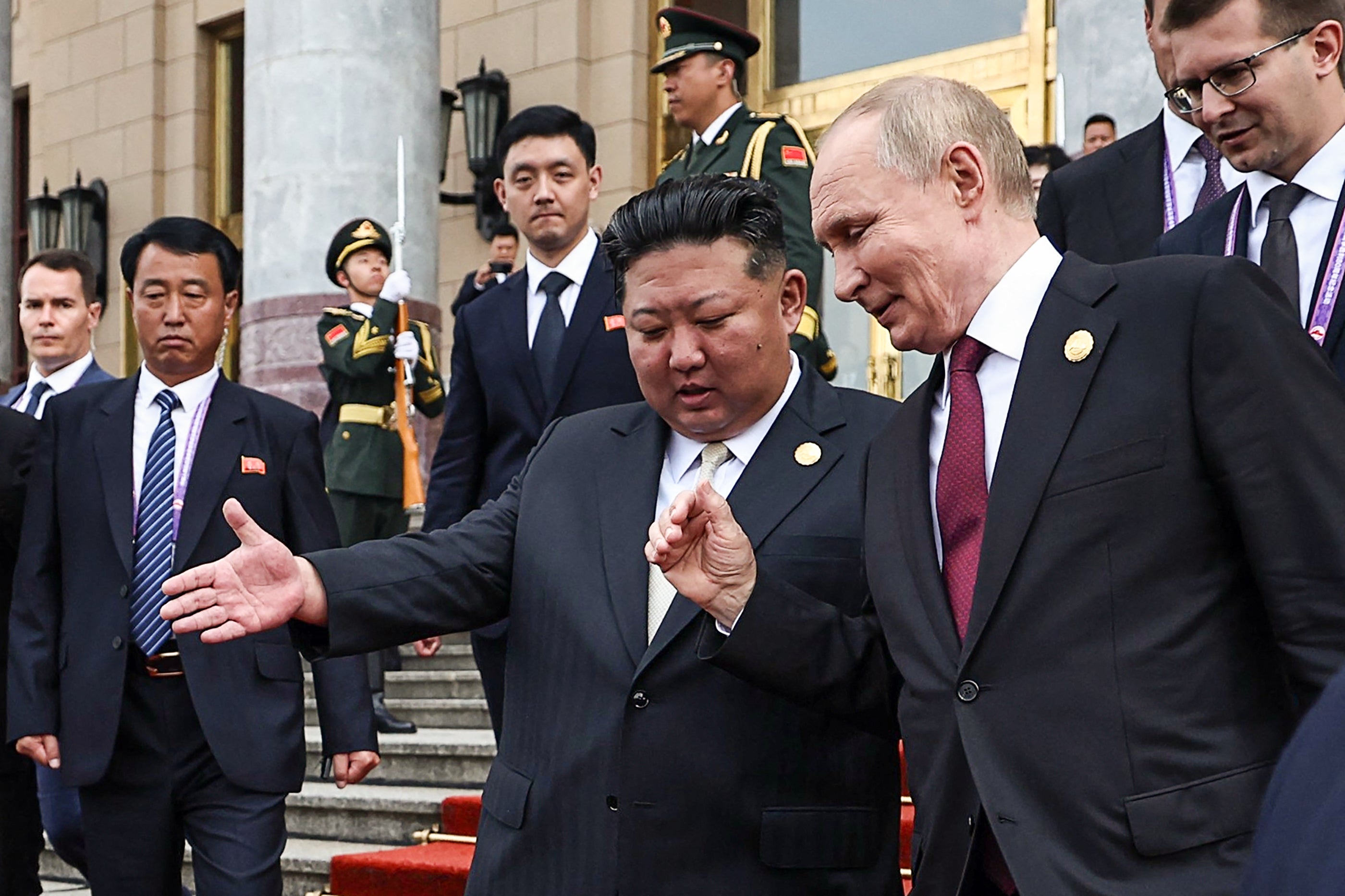 Russia's President Vladimir Putin (R) and North Korea's leader Kim Jong Un (C) leave after their meeting in Beijing on September 3, 2025