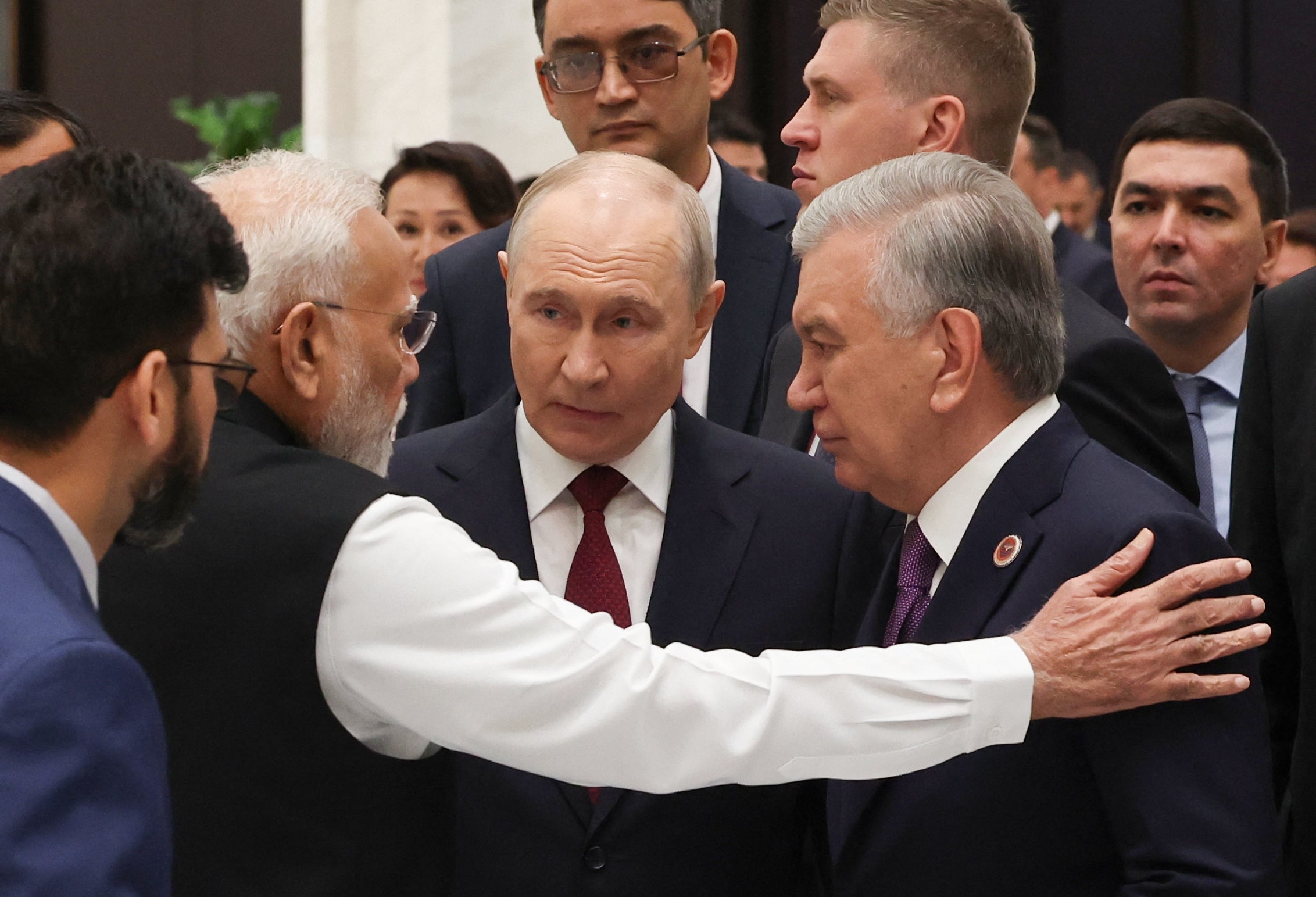 Indian Prime Minister Narendra Modi, Russia's President Vladimir Putin and Uzbekistan's President Shavkat Mirziyoyev interact as they arrive for a reception in honour of participants in the Shanghai Cooperation Organisation (SCO) summit
