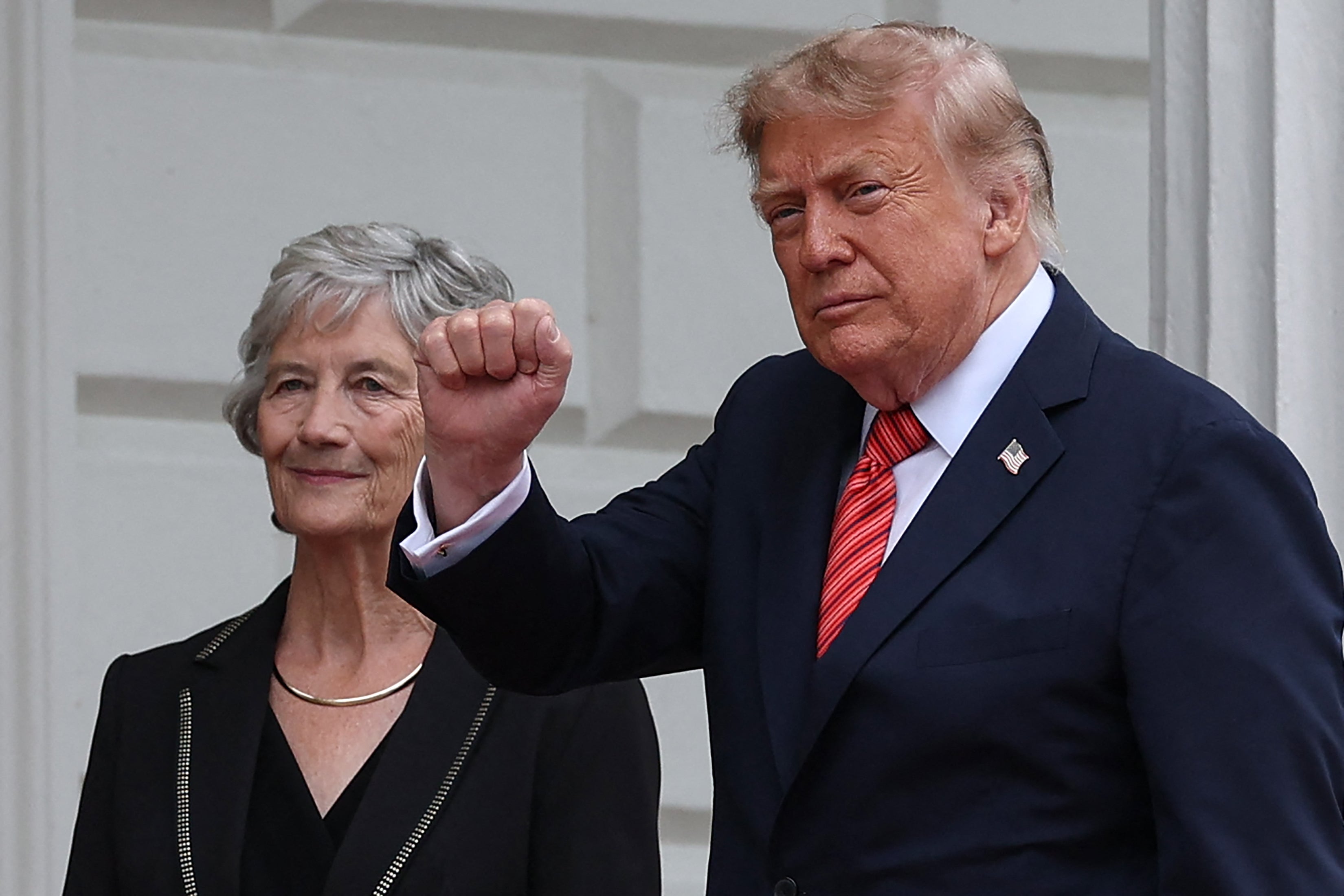 Mr Trump gestures as he is welcomed by Ireland's president Catherine Connolly at Áras an Uachtaráin in Phoenix Park in the Irish capital Dublin