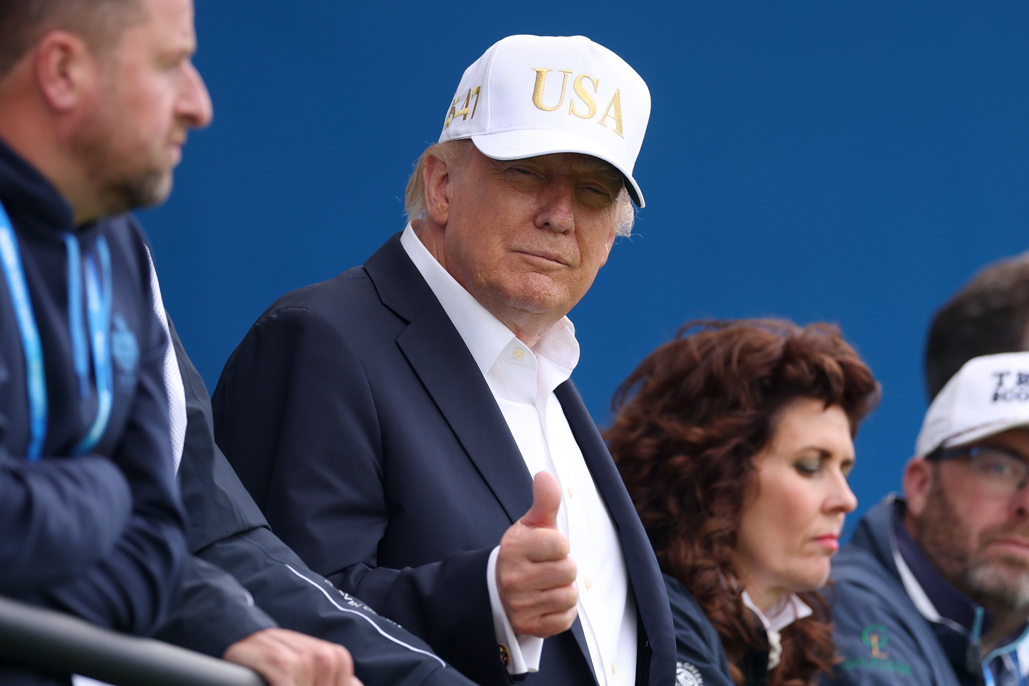 Trump gestures a thumbs up as he looks across the 18th green on day three of the Amgen Irish Open at Trump International Golf Links in Doonbeg