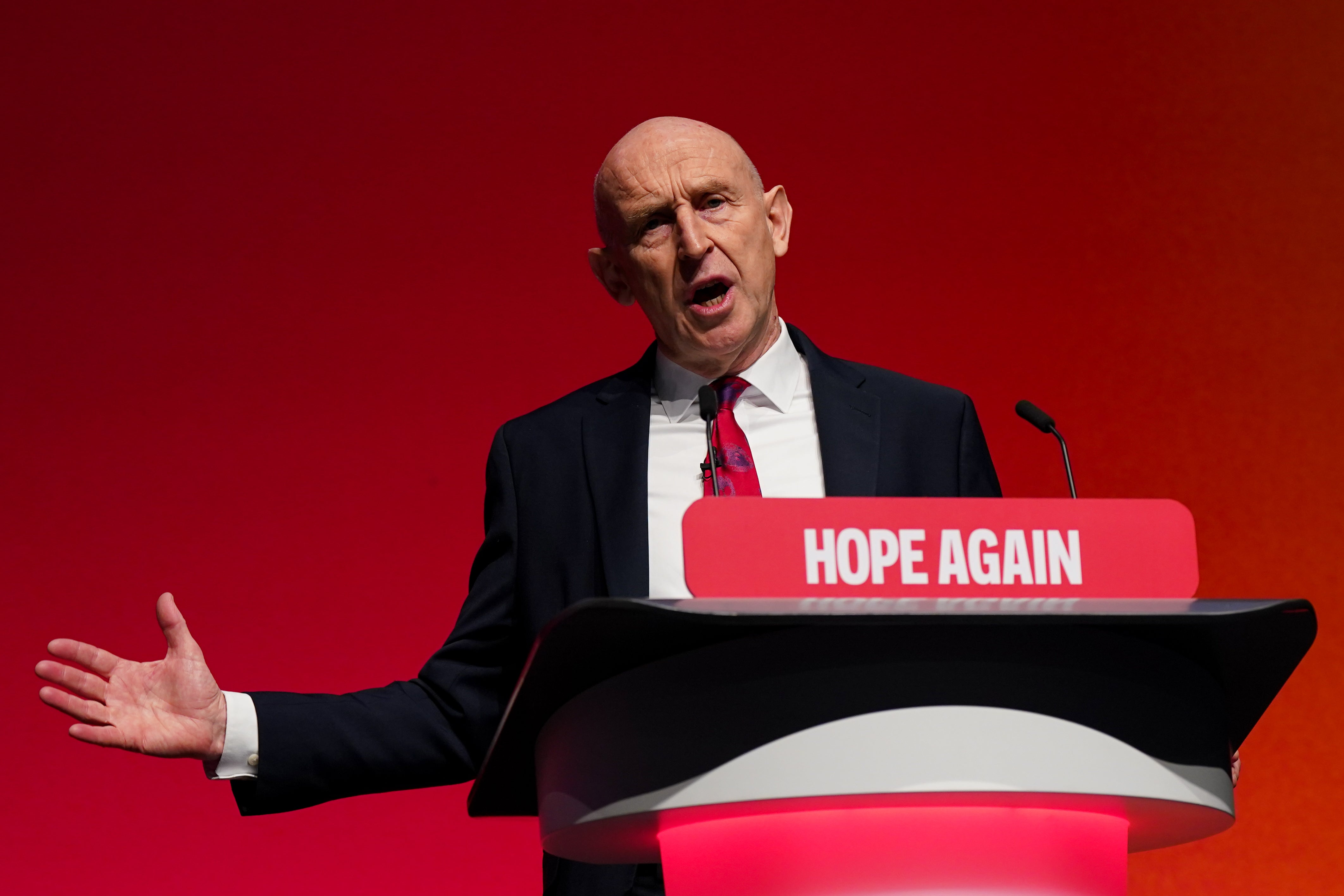 John Healey delivering his speech in Liverpool