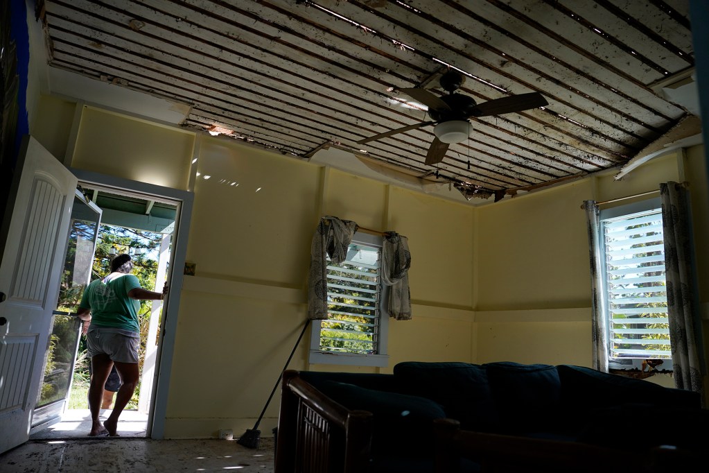 Sunlight filters through the ceiling in this Wainiha home Wednesday, Sept. 9, 2026. The homeowner sought refuge at her brother’s house next door. Her garage was also flattened. She did not want to be identified by name. (Kevin Fujii/Civil Beat/2026)