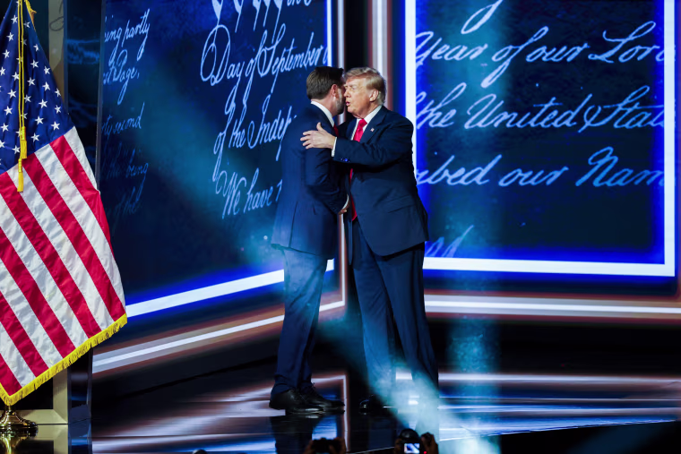 U.S. Vice President JD Vance, left, greets President Donald Trump.