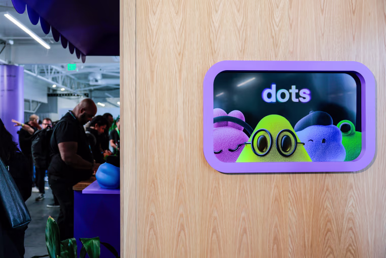 A sign for "dots", virtual AI agents shaped like blobs of different colors wearing glasses, berets, and headphones