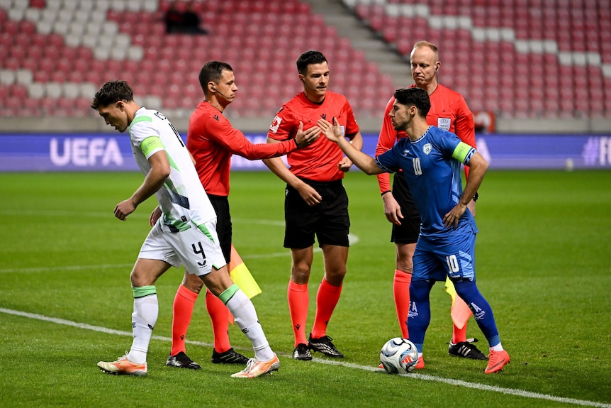 Ireland captain Dara O'Shea walks away from Israel captain Manor Solomon at the handshakes before a football match.