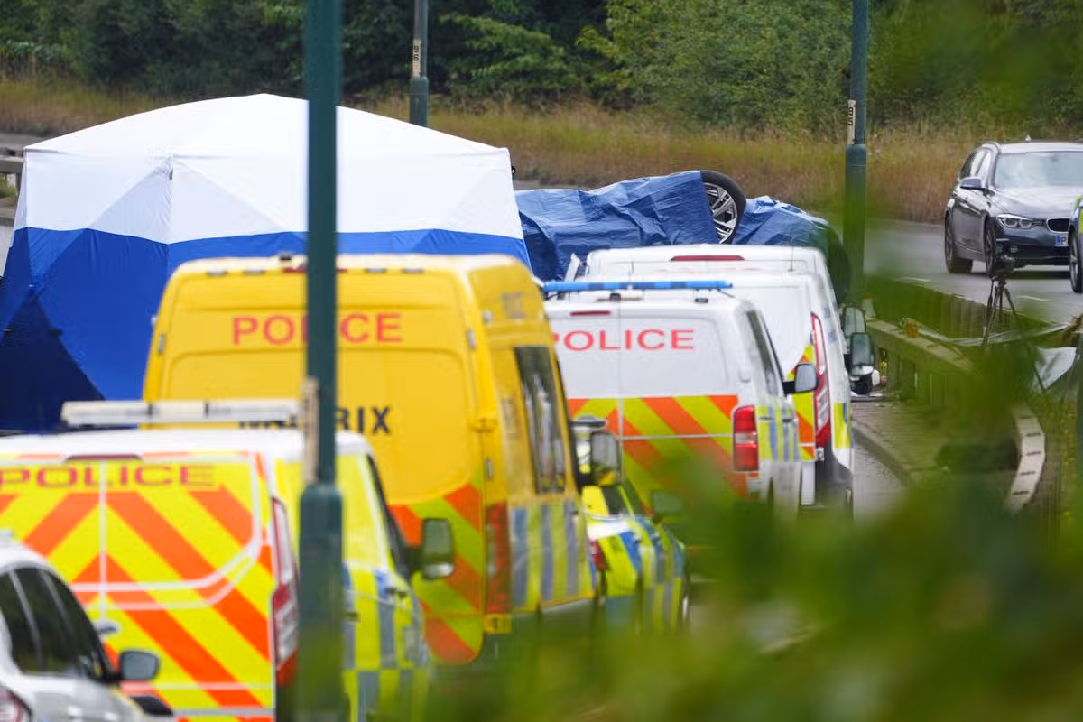 Police officers at the scene of a fatal crash involving a police car and a Volkswagen Passat on the A66 in South Bank, near Middlesbrough.
