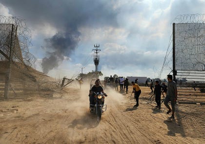 Palestinians infiltrate the Israeli side of the Gaza border fence on October 7, 2023. Credit: Hani Alshaer/Anadolu Agency via Reuters Conne Palestinians infiltrate the Israeli side of the Gaza border fence on October 7, 2023.