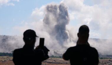 People from Mansouri record the smoke billowing from an Israeli-controlled detonation destroying their village, as seen from Hanniyeh village, southern Lebanon, on Sept. 11, 2026.