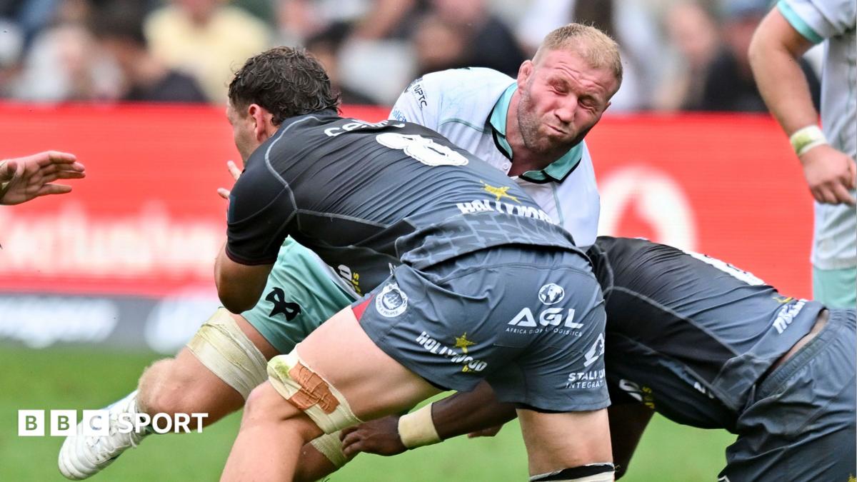 Ospreys flanker Ross Moriarty winces while tackled by Sharks