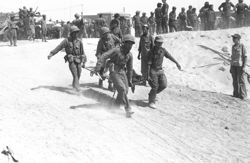 IDF medical crew evacuating an injured soldier from the battle field during Yom Kippur War