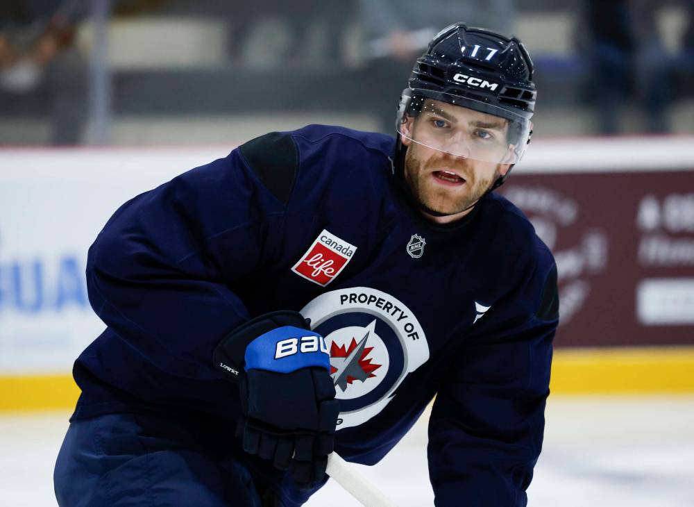 John Woods / THE CANADIAN PRESS
Winnipeg Jets captain Adam Lowry said Friday the team ‘had an inkling’ franchise netminder Connor Hellebuyck wasn’t going to report to training camp this week.