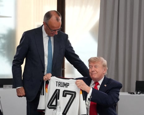 US president Donald Trump holds up a jersey with the number 47 as German chancellor Friedrich Merz look on during a working session at the G7 summit in Evian-les-Bains, France in June.