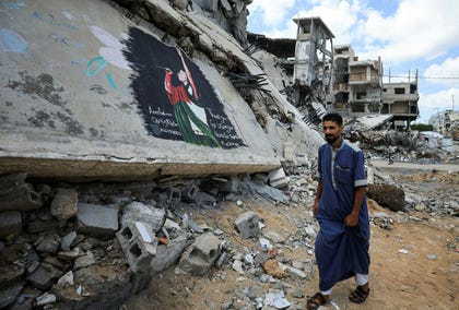 A Palestinian walks past a mural painted in honour of American rapper Macklemore, amid buildings destroyed during the war, in Gaza City, Friday. Credit: DAWOUD ABU ALKAS/REUTERS A Palestinian walks past a mural painted in honour of American rapper Macklemore, amid buildings destroyed during the war, in Gaza City, Friday.