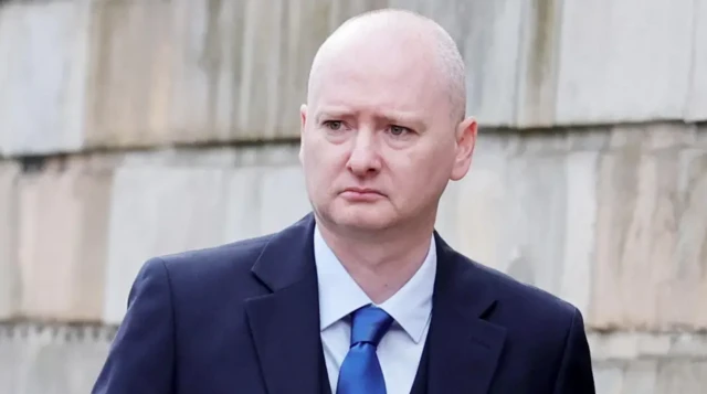 Graeme Dott in a suit, shirt and tie outside court during his trial