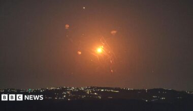 A red and orange missile being intercepted by Jordanian air defences in the sky as seen from the Israeli side of the Jordan Valley.