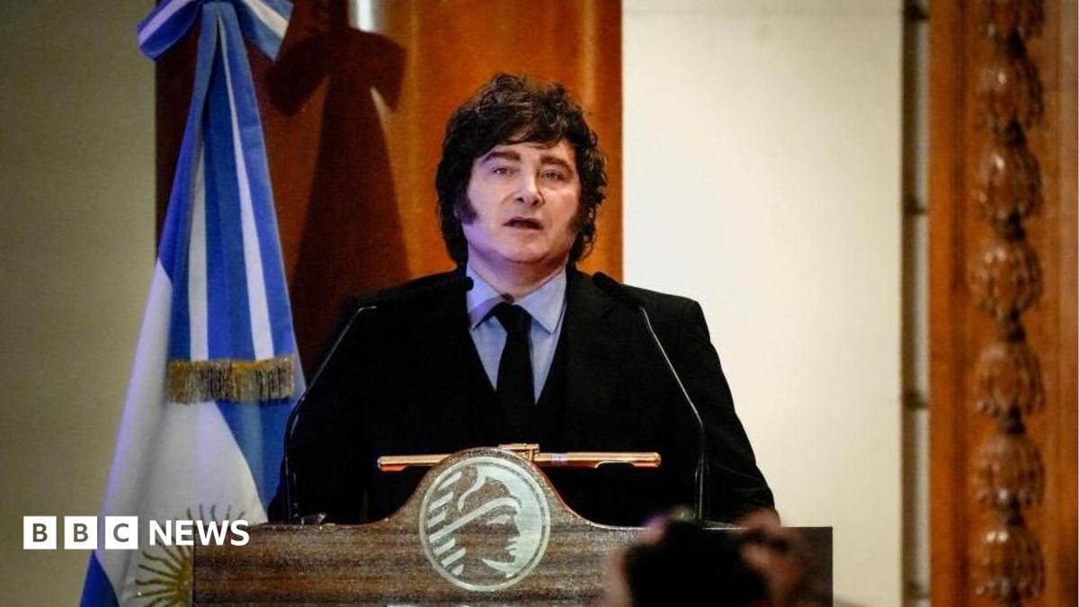 Argentine President speaks during a ceremony commemorating the 172nd anniversary of the Buenos Aires Stock Exchange in Buenos Aires, Argentina, July 16, 2026. He is wearing a dark suit with a black tie and a light blue shirt. He stands at a lectern and to his left there is an Argentine flag.